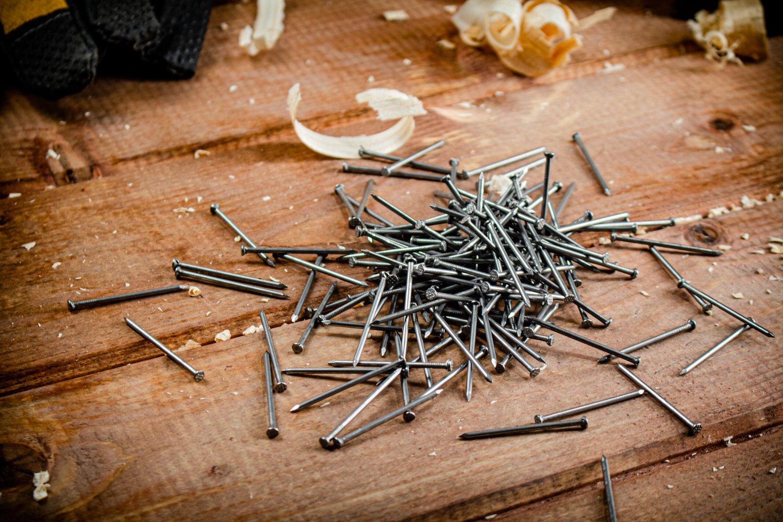Construction nails on the table. On a wooden background. High quality photo